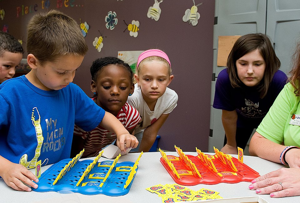 School age children playing the game Guess Who in 2014.